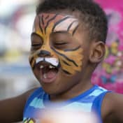 Kid with painted lion face