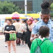 Cop speaking to a kid at a mural party