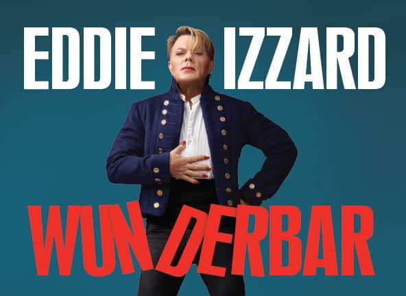 Eddie Izzard stands proudly in blue naval jacket