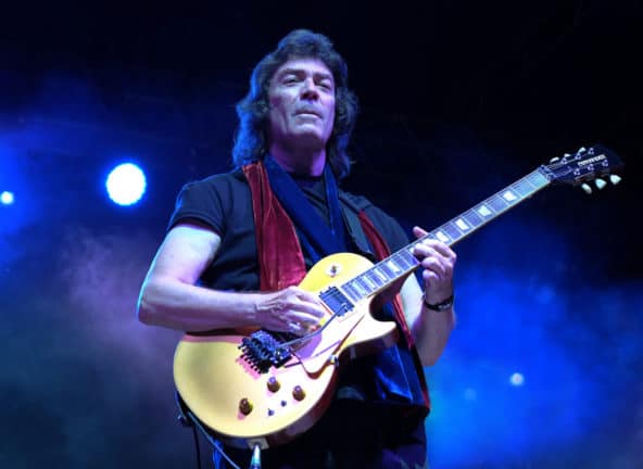 Steve Hacket playing a yellow six-string electric guitar