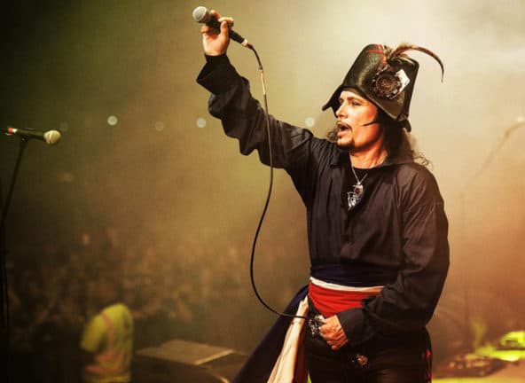 Adam Ant on stag holding microphone to audience
