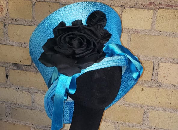 Grace - blue hat with black flower and blue ribbon
