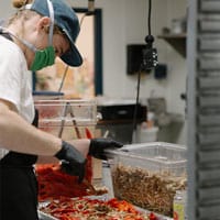 Chowgirls employee prepping food
