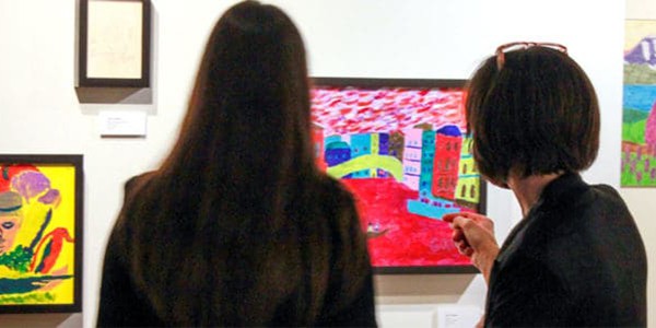 two women viewing an art gallery