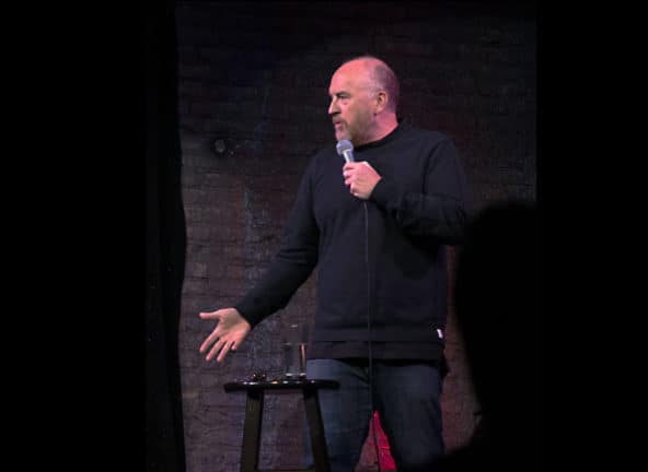 Louis CK performs at a show