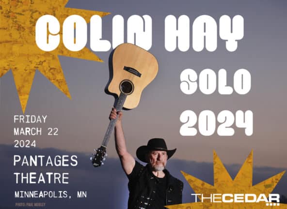 Colin Hay Solo 2024. Friday, March 22, 2024; Pantages Theatre, Minneapolis, MN. Colin Hay wearing a black shirt and black vest holding a guitar upside down by the middle of the neck.