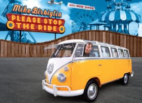Collage-style artist graphic showing Mike Birbiglia driving an old VW bus sticking his head out the window parked outside an amusement park with a roller coaster and tent in the background. The show's title Mike Birbiglia Please Stop The Ride appears in a theme park-like sign in the top left corner